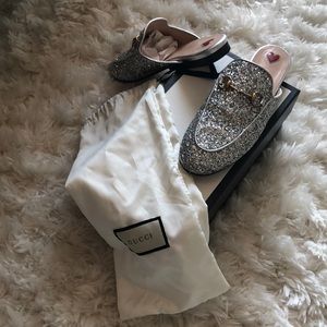 Silver Gucci loafer slides.